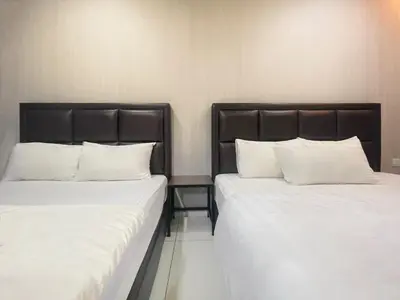 two beds sitting next to each other in a room at Hilltop Hotel Tanjung Malim in Tanjung Malim