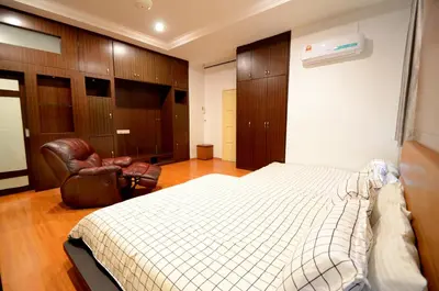 a bedroom with a bed and a chair in it at Decozy 3.0 Semi-D in Ipoh