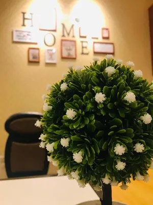 a vase filled with white flowers on a table at Decozy 3.0 Semi-D in Ipoh