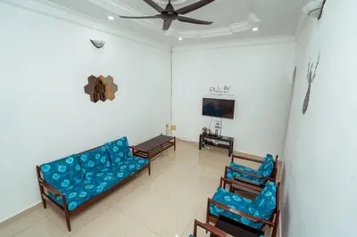 a living room with a couch and two chairs at GLYSM Tambun Stay 