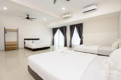 a bedroom with two beds and a mirror at Ipoh Luxury Suites by Verve (18 Pax) EECH16 in Ipoh