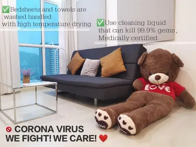 a large brown teddy bear sitting in a living room at Penang Straits Garden Condominium Georgetown in George Town