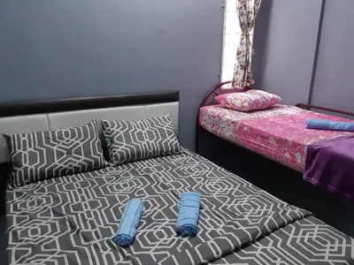 a bedroom with a bed and pillows on a bed sidx sidx sidx at Anis Homestay Gua Musang in Gua Musang