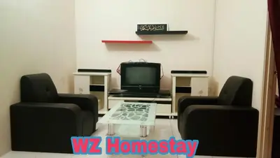 a living room with two chairs and a tv at Double Storey @ Tapah in Tapah