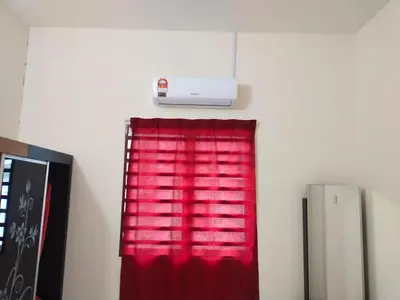 a room with a red curtain and a heater at Double Storey @ Tapah in Tapah