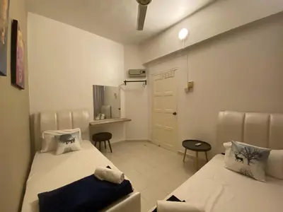 a small room with two beds and a kitchen at Arcadia Penang by Plush in George Town