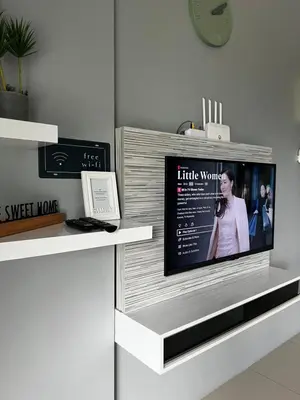 a flat screen tv on a shelf in a room at Casahome by Irdina Meru- 8pax -10pax in Ipoh