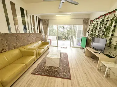 a living room with a yellow couch and a television at The Haven Retreat B7-2-1 ( Silverpark) in Bukit Fraser