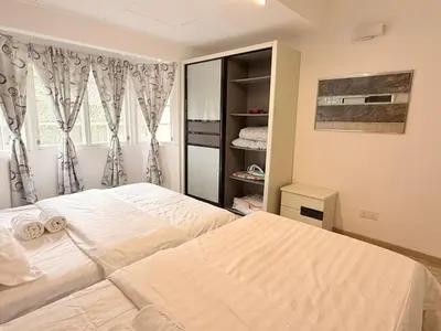 a bedroom with a large bed and a window at The Haven Retreat B7-2-1 ( Silverpark) in Bukit Fraser