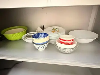 a shelf full of bowls and plates on a shelf at The Haven Retreat B7-2-1 ( Silverpark) in Bukit Fraser