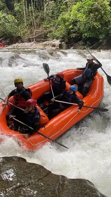 a group of people in a raft in a river at Outworld Basecamp in Gopeng