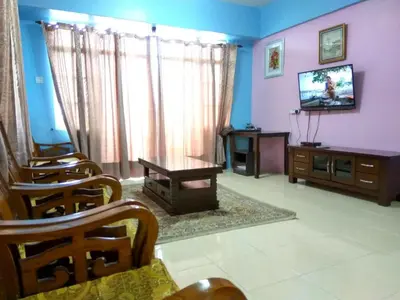 a living room with purple walls and a tv at Tenang & Tranquil Homestay - B605 Cameron Highlands in Brinchang