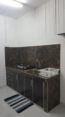 a kitchen with a sink and a counter top at Homestay / Roomstay Muslim Budget Tanjung Malim in Tanjung Malim