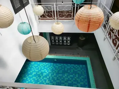 an overhead view of a swimming pool with hanging lights at The Boutique Residence Hotel in George Town