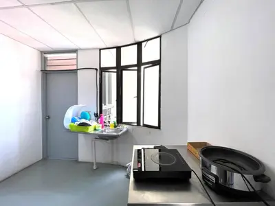 a room with a table and a sink and a window at Hotel O Wg Guest House in George Town