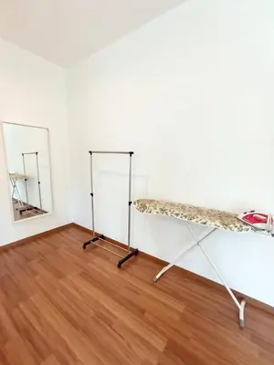 a room with a shelf and a mirror at TROPICAL LIVINGS MERU IPOH HOMESTAY by Grab A Stay in Ipoh