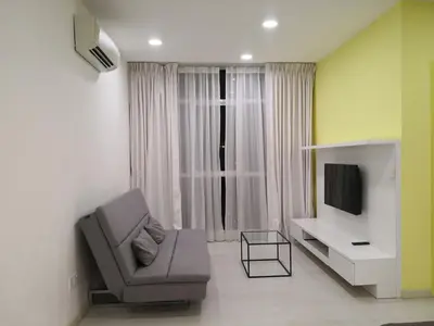 a living room with a chair and a television at Strait Garden Suites X Ace Pro @ George Town in Jelutong
