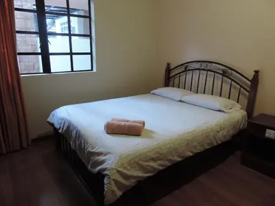 a bed with a towel on it in a bedroom at Cameronian Inn in Cameron Highlands