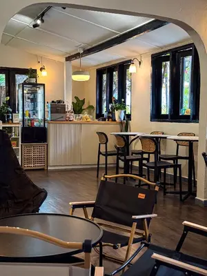 an empty restaurant with tables and chairs and a counter at Cameronian Inn in Cameron Highlands