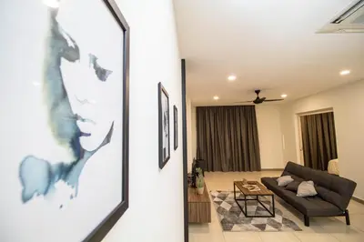 a living room with a couch and a table at Octagon Ipoh by Plush in Ipoh
