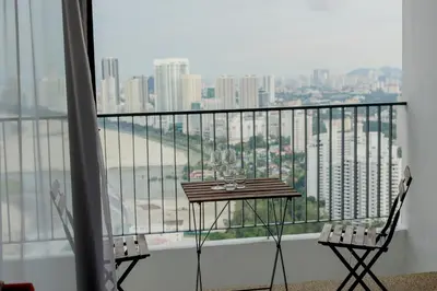 a table and two chairs on a balcony with a view at The Landmark Condo, by Sanguine in George Town