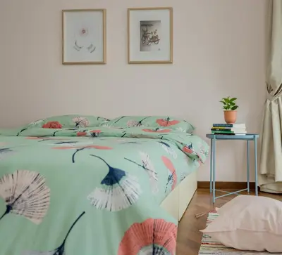 a bedroom with a bed with a colorful comforter at The Landmark Condo, by Sanguine in George Town