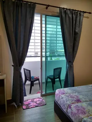 a bedroom with two chairs and a bed and a window at Premium Garden Home 17 Golden Hills in Brinchang