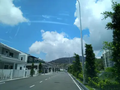 an empty street with a blue sky and clouds at Premium Garden Home 17 Golden Hills in Brinchang