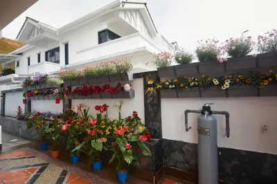 a bunch of flowers in pots on the side of a building at Ahn-Yi Residence in Brinchang