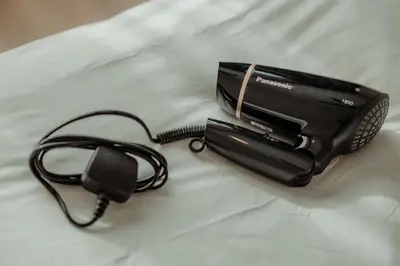 a black phone with a cord on a bed at Muji X Tiffany - City and Hill View 3BR at 218 Tropicana NEAR Komtar Food Heaven with Netflix & TV Box in George Town