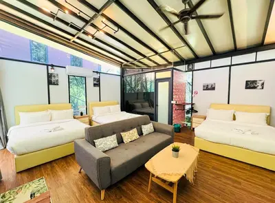 a living room with two beds and a couch at Xscape Tambun in Ipoh