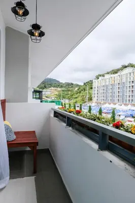 a balcony with a bench and a view of a building at Comfy Sofy 21- Backyard Garden- Night Market area in Cameron Highlands