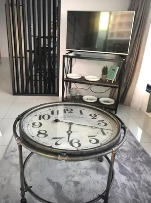 a clock sitting on a table in a room at SUNRISE Gurney Seaview Luxury Duplex in George Town