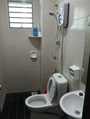 a small bathroom with a toilet and a sink at Purple TownHouse 9pax 3R2B Wifi in Sekincan