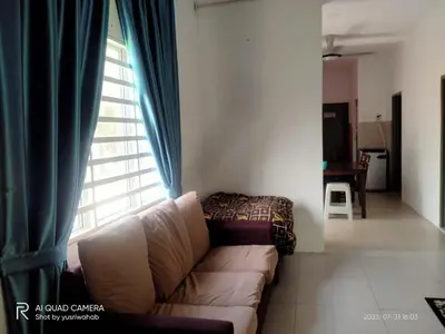 a living room with a couch in front of a window at Sri Manik Guest House Tanjung Karang in Tanjung Karang