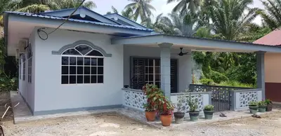 a house with a white door and potted plants at Atocha Homestay - Terong@Taiping in Kampong Salak