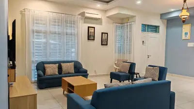 a living room with two blue couches and a table at Ocean 25 Shamrock Beach Big Group 6 Bedroom 5 Bathroom with Pool in Tanjung Bungah