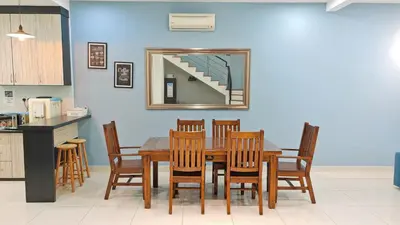 a dining room table with wooden chairs and a mirror at Ocean 25 Shamrock Beach Big Group 6 Bedroom 5 Bathroom with Pool in Tanjung Bungah