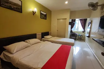 a hotel room with two beds and a window at Heaven Mountain Hill 2 Cameron Highlands in Cameron Highlands