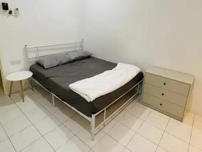 a small bedroom with a bed and a night stand at 22 Haus in Bukit Mertajam