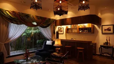 a living room with a bar and a large window at Kinta Bali Villa in Ipoh