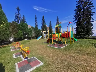 a park with a playground with a slide at Little England B8 in Bukit Fraser