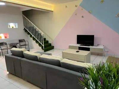 a living room with a couch and a tv at Seri Manjung HomeStay @Spacious Family Home in Seri Manjung