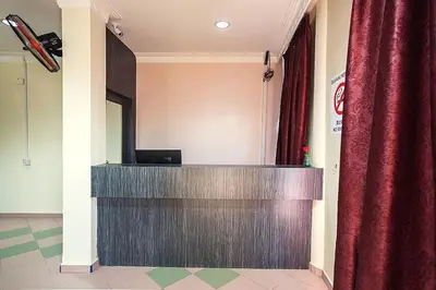 a podium in a room with a red curtain at T P Hotel in Sitiawan