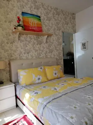 a bedroom with a bed with yellow sheets at Alyaleesya Muslim Homestay in Tanah Rata