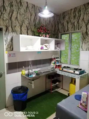 a small kitchen with a sink and a counter at Alyaleesya Muslim Homestay in Tanah Rata