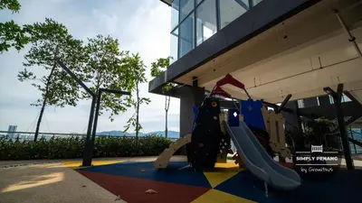 a playground with a slide in front of a building at Tropicana 218 Macalister by Simply Penang in George Town