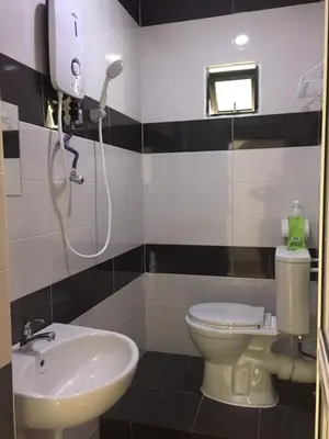 a bathroom with a toilet and a sink at COMFORTABLE STAY in Ayer Itam
