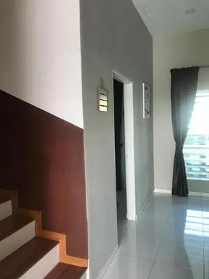 a living room with a staircase and a window at Ipoh Water Front City Homestay in Ipoh