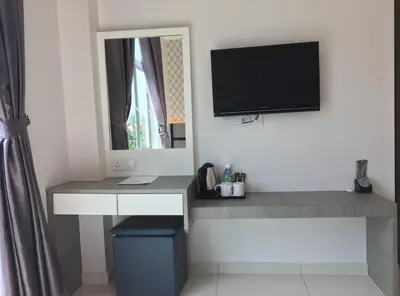 a room with a desk with a tv on the wall at B&L HOTEl in Sungkai